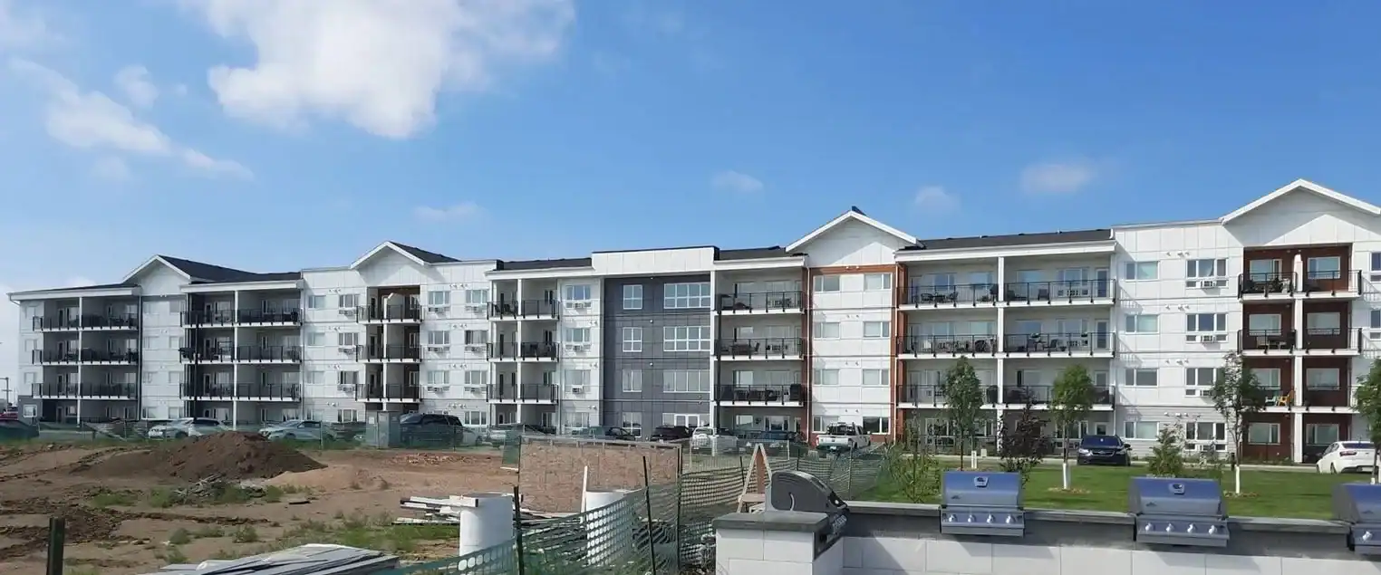 Large Scale Multi Family Exterior Painting Projects Expansive view of a modern multi family apartment building with multiple units and balconies, ready for painting.