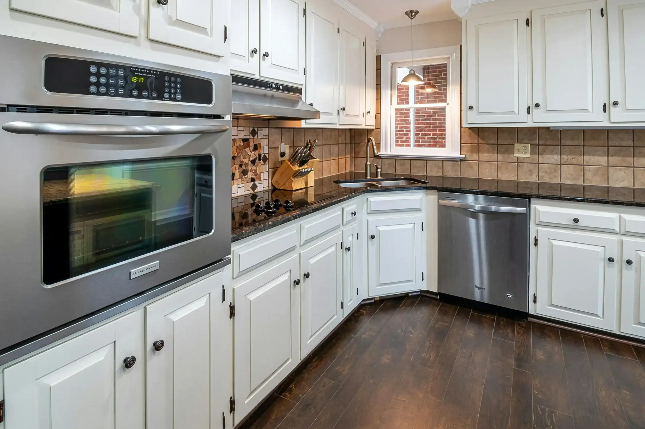 Beautiful Kitchen with White Painted Cabinets A beautifully painted kitchen with white cabinets, dark countertops, and stainless steel appliances.