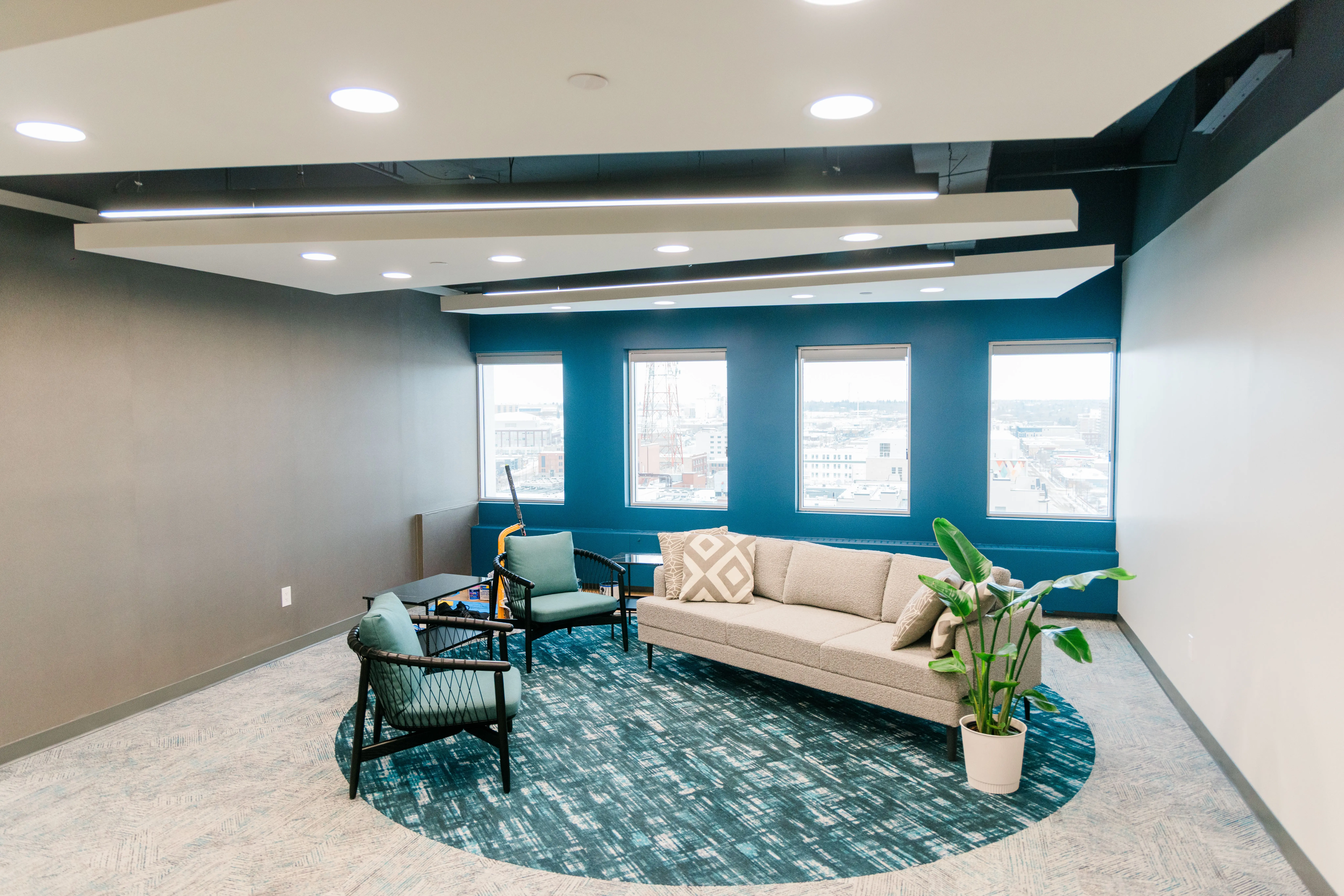 Modern Office Interior Painting with Accent Wall A newly painted modern office interior featuring a striking teal accent wall, neutral grey walls, and white ceilings.